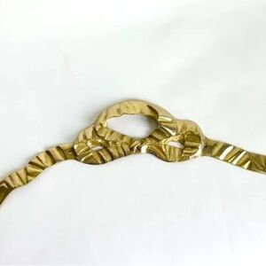 Solid brass decorative ribbon tied in bow